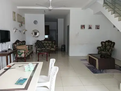 a living room with a table and chairs at Taman yu sungai besar in Sungai Besar