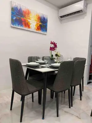 a dining room table with chairs and a painting at Love birds Abbie's Private Pool Villa 2 pax in Bukit Mertajam