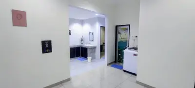 a white bathroom with a sink and a mirror at 18pax Bungalow Homestay Hutan Melintang in Hutan Melintang