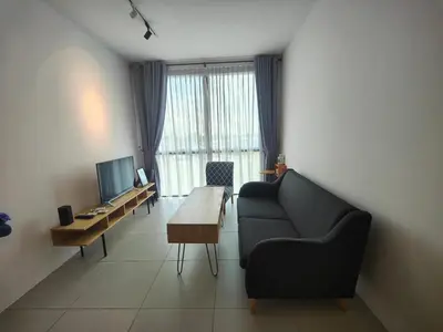 a living room with a couch and a table at Cozy City Stay at Kuching Prime location in Gua Sai