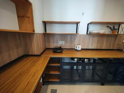 a room with a wooden desk with a phone on it at Cozy City Stay at Kuching Prime location in Gua Sai