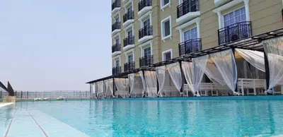 a large swimming pool in front of a building at JJ's Modern Suite Kampar- Near UTAR in Kampar