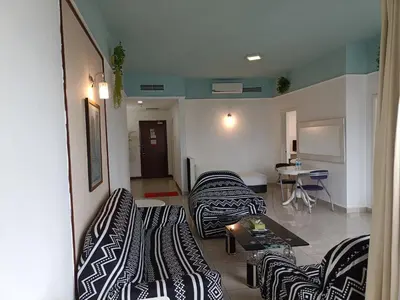 a living room with several couches and a table at Kuala Lumpur Residence At Hotel Times square in Gua Sai
