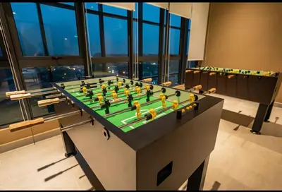 a chess game on a table in a room with windows at Theme Park Ipoh - Onsen Premier Suites By LUX SUITE in Ipoh