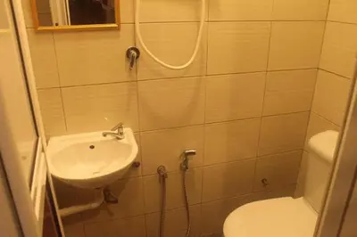 a small bathroom with a sink and a toilet at Ros Heritage Motel in George Town