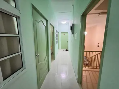 an empty hallway with green walls and a door at KISABEL Budget Hotel in Tanah Rata