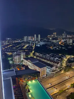 a view of a city at night with a building at Wanderlust Retreat Studio by Iconic Regency in Bayan Lepas