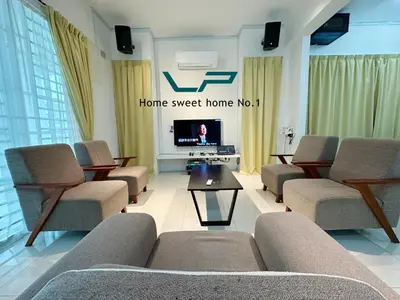 a living room with couches and a tv in a room at Penang Balik Pulau BBQ & KARAOKE Home in Balik Pulau