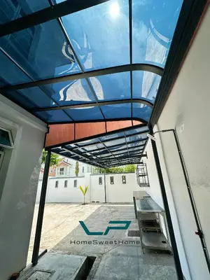 a glass roof on a building with a table at Penang Balik Pulau BBQ & KARAOKE Home in Balik Pulau