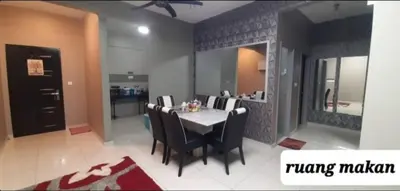 a dining room with a white table and chairs at D'PrimaVerra in Ipoh