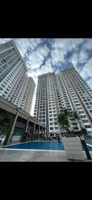 a tall building with a pool in front of it at D'PrimaVerra in Ipoh