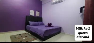 a purple bed in a room with a purple wall at D'PrimaVerra in Ipoh