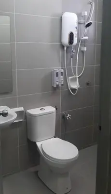 a bathroom with a white toilet and a shower at D'PrimaVerra in Ipoh