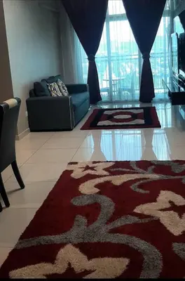 a living room with a couch and a rug at D'PrimaVerra in Ipoh
