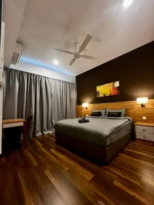 a bedroom with a bed and a ceiling fan at Sunway Onsen Ipoh by EUcation Home in Tambun