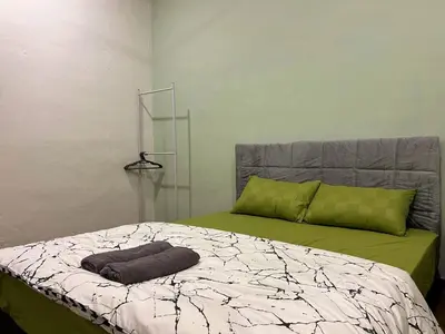 a bed with a pillow on it in a room at Modern Casual Style Haus 4Room`````Alma in Bukit Mertajam