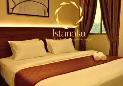 a bed in a hotel room with two towels on it at Hotel Istanaku , Ipoh, Perak in Ipoh