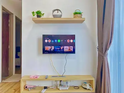 a living room with a tv on a wall at #2 Hann's Residence Homestay Sunset View 2R2B in Gua Sai