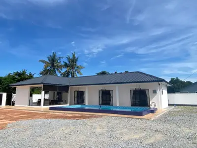 a house with a swimming pool in front of it at Untung5tay in Gua Sai