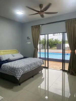 a bedroom with a bed and a swimming pool at Untung5tay in Gua Sai