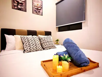 a bed with a wooden tray on top of it at Ipoh Manhattan Waterpark Suite by City Home Empire MHA306 in Ipoh