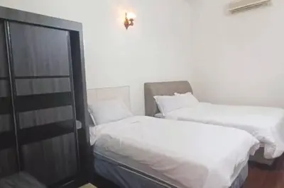 two beds sitting next to each other in a room at Y.s.a Homestay(100mbps Wifi) in Ipoh