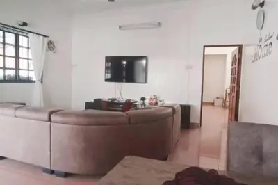 a living room with a couch and a flat screen tv at Y.s.a Homestay(100mbps Wifi) in Ipoh