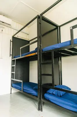 a bunk bed with blue bunk beds in a room at KITA Hostel in George Town