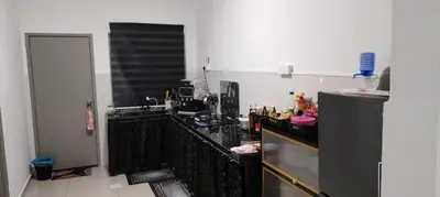 a kitchen with a black counter and a refrigerator at MiAmorHomestay in Gua Sai