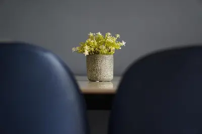 a vase of flowers sitting on a table with two chairs at L13 Cozy Corner The Horizon Ipoh in Ipoh