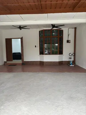 a large room with a ceiling fan and windows at Bidor Homestay in Bidur
