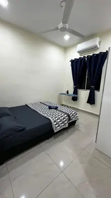 a bedroom with a bed with blue curtains at Luna De Haus Homestay in Sungai Petani
