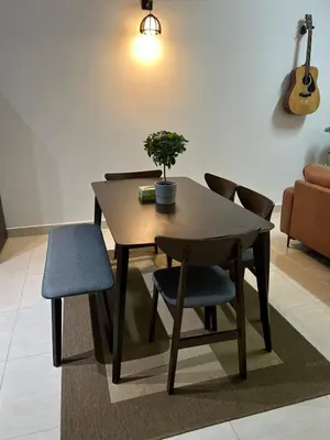a dining room table with a potted plant and chairs at berTIGA Homestay Bertam in Kepala Batas