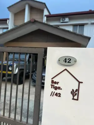 a sign in front of a house with a for sale sign at berTIGA Homestay Bertam in Kepala Batas