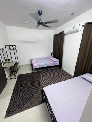a bedroom with two beds and a ceiling fan at berTIGA Homestay Bertam in Kepala Batas
