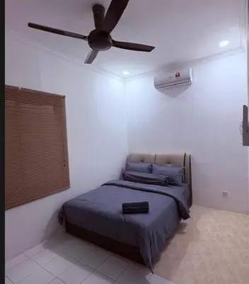 a bedroom with a bed with a ceiling fan at Saujana Number 5 in Gua Sai