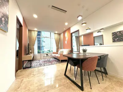 a living room with a table and a couch at Sky Suites Peaches 2BR nearby KLCC in Gua Sai
