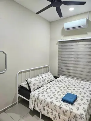 a bedroom with a bed and a ceiling fan at Adam Homestay in Gua Sai