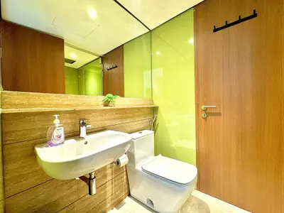 a bathroom with a sink and a toilet and a mirror at Sky Suites Peaches 2BR Nearby KLCC in Gua Sai