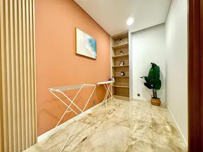 a hallway with orange walls and a plant at Sky Suites Peaches 2BR Nearby KLCC in Gua Sai