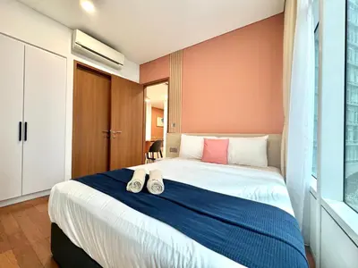 a bedroom with a bed with shoes on it at Sky Suites Peaches 2BR Nearby KLCC in Gua Sai
