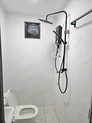 a bathroom with a shower with a toilet at Adam Homestay in Gua Sai