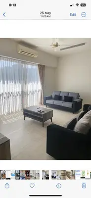a living room with a couch and a coffee table at By The Sea in Batu Ferringhi
