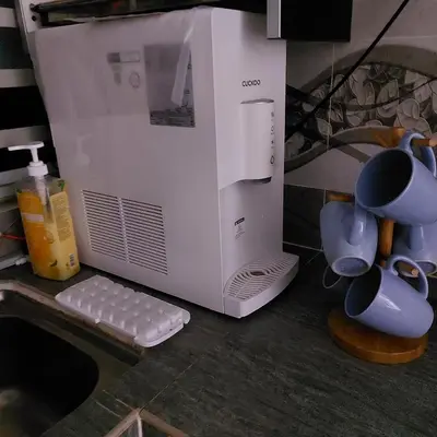 a white microwave sitting on a counter with cups at Alisa Homestay in Lunas