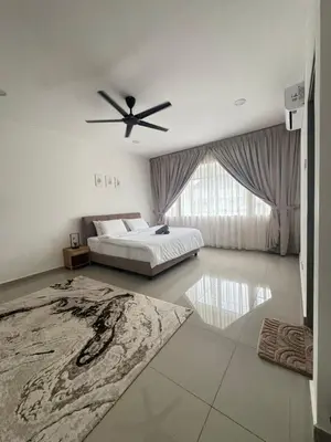 a bedroom with a bed and a ceiling fan at Casa De Olive Islamic Only in Kampong Batu Lapan