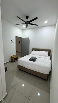 a bedroom with a bed with a ceiling fan at Casa De Olive Islamic Only in Kampong Batu Lapan