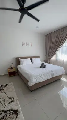 a bedroom with a large bed with a ceiling fan at Casa De Olive Islamic Only in Kampong Batu Lapan