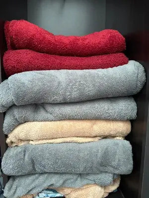 a pile of towels stacked on top of each other at Dlaili Homestay in Tanjung Karang