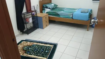a bedroom with a bed and a rug on the floor at Homestay kita in Gua Sai