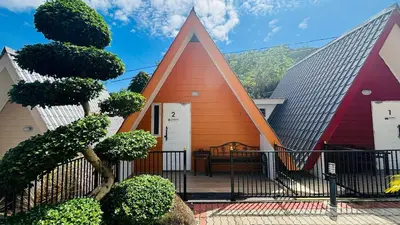 a small house with a red and orange at Capital O 91167 Gemilang Candi Resort in Kampong Baru